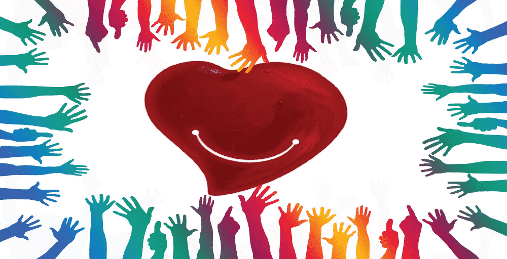 different coloured hands reach out to a red heart.