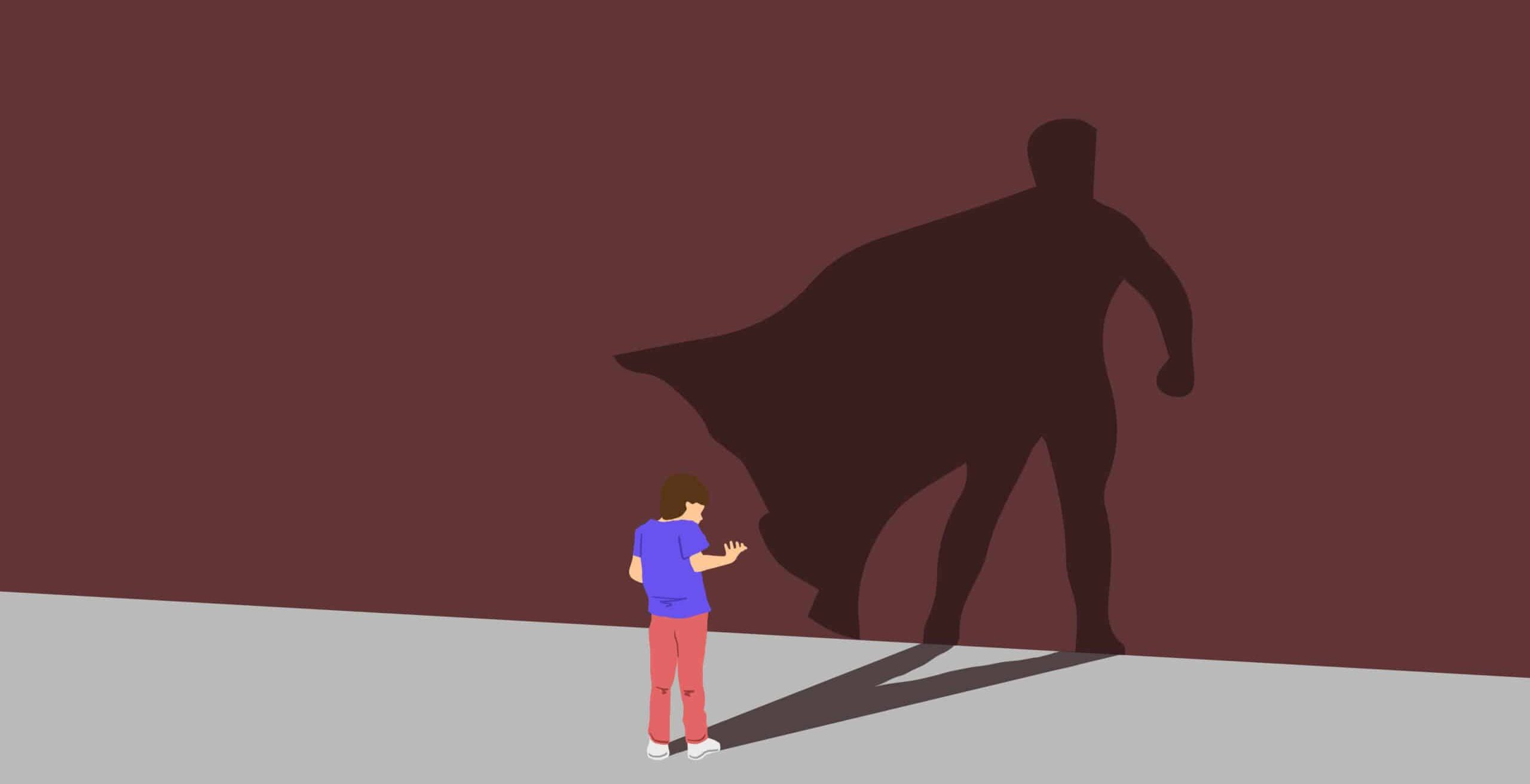 cartoon boy in red pants and blue shirt looks at wall with his shadow of a superhero in a cape