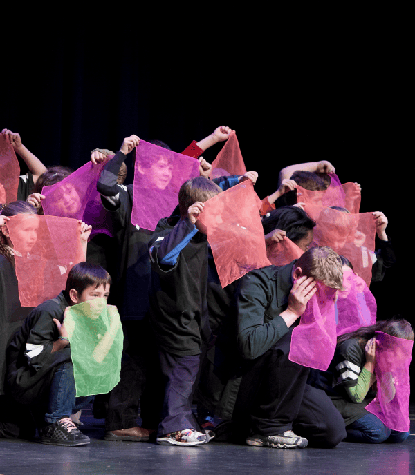 children pose with coloured scarves