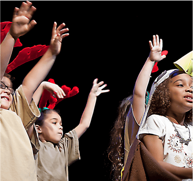 a group of children hold their hands up