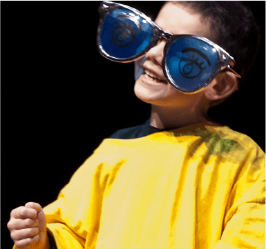 boy wears a yellow shirt and silver frame glasses with blue lens